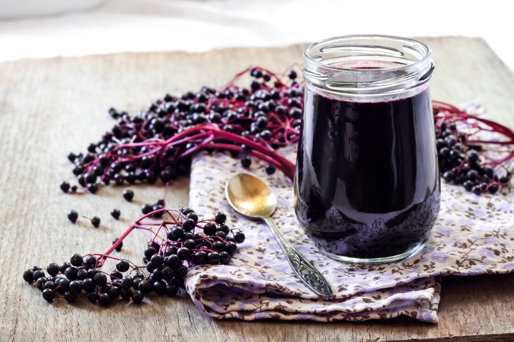 Homemade black elderberry syrup in glass jar